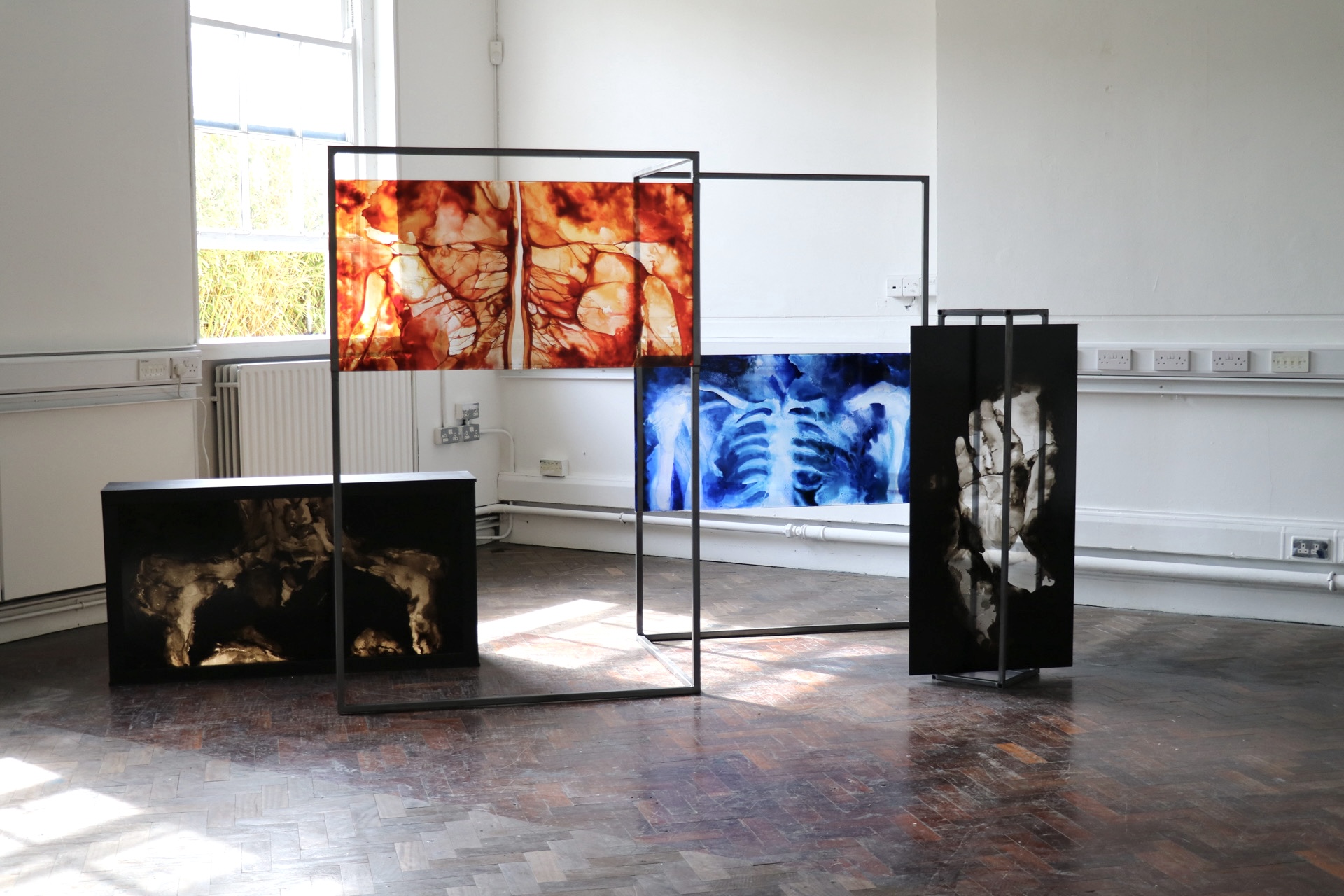 Installation view of a steel structure with perspex painting inserted at eye level.
