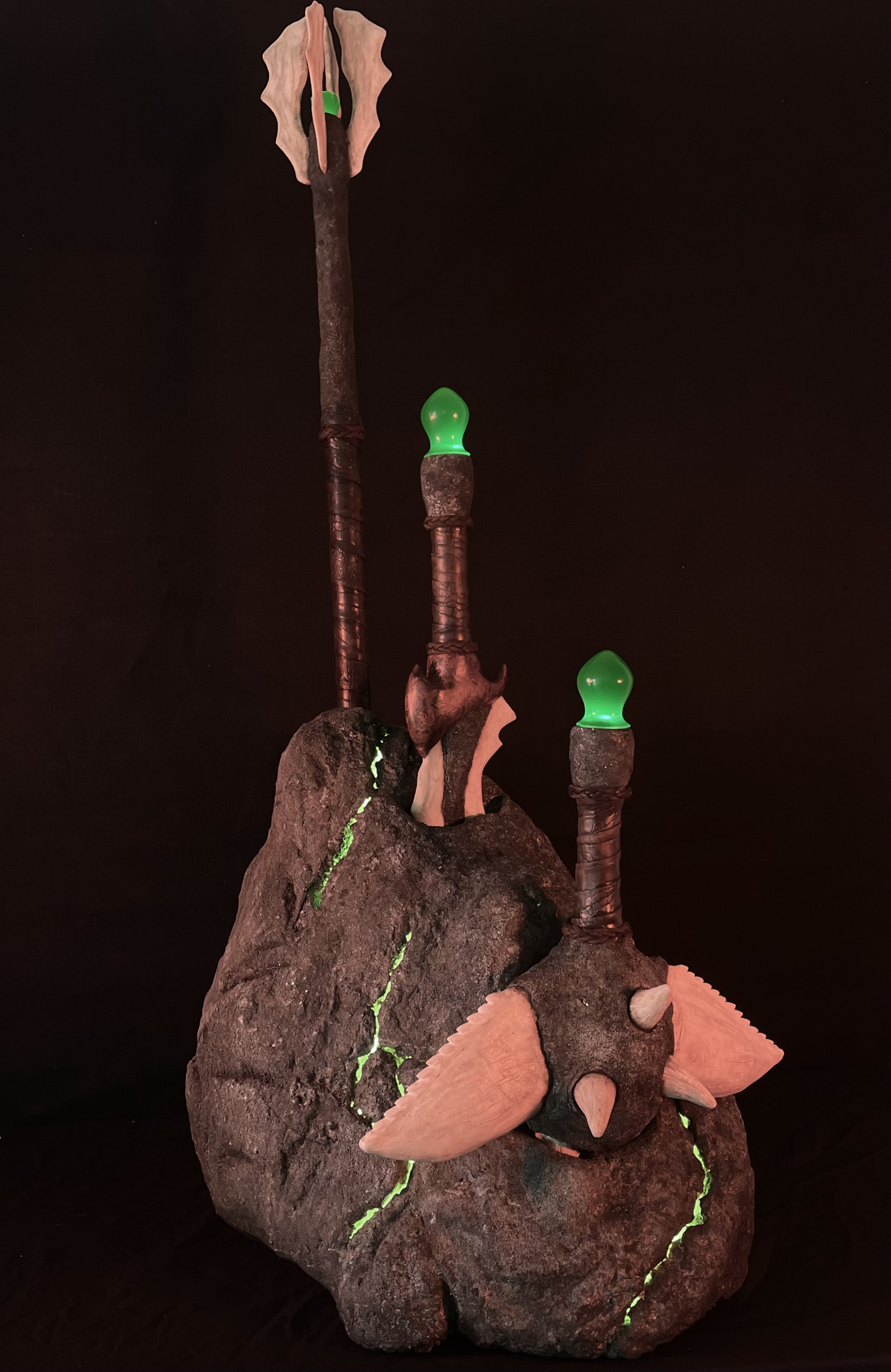 Sacred weaponry and ceremonial stone from a prehistoric fantasy world.