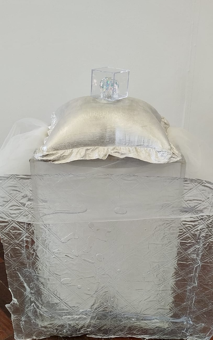 Marie Noonan, **R_dact_d**, 2026, Jesmonite Cushion, cube and epoxy resin.
