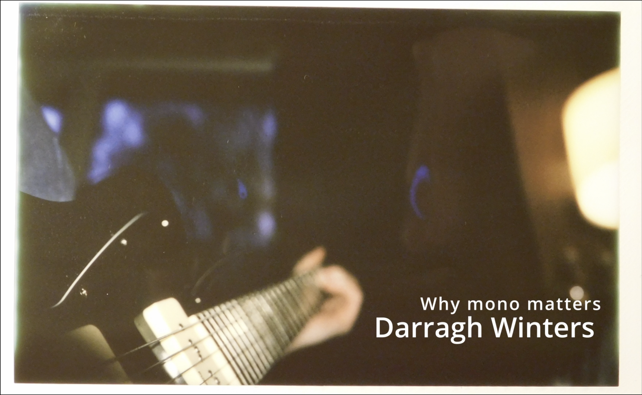 Instant photo of holding a guitar, with the project title "Why mono matters" by Darragh Winters.