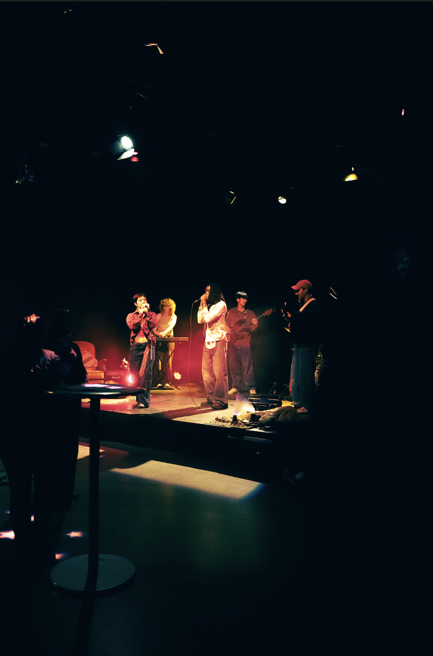 artists + Band performing on stage