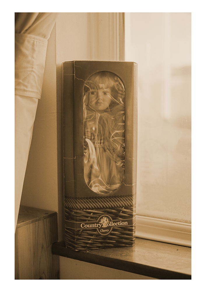 A porcelain doll still in its original packaging