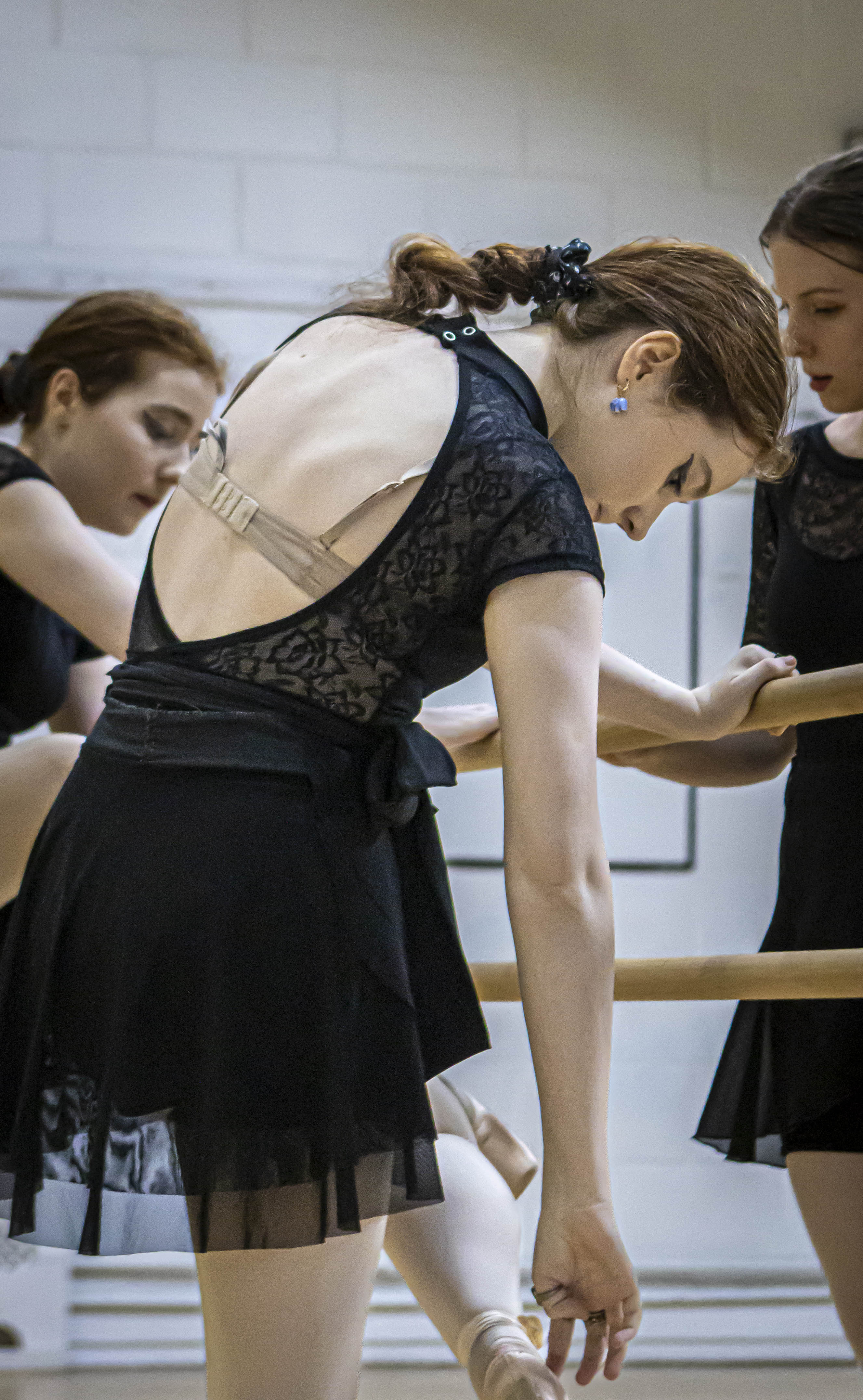 Ballet dancer fixing shoe