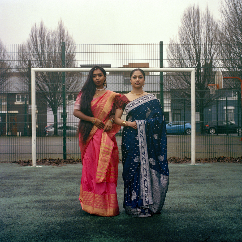 two indian women standing in a park