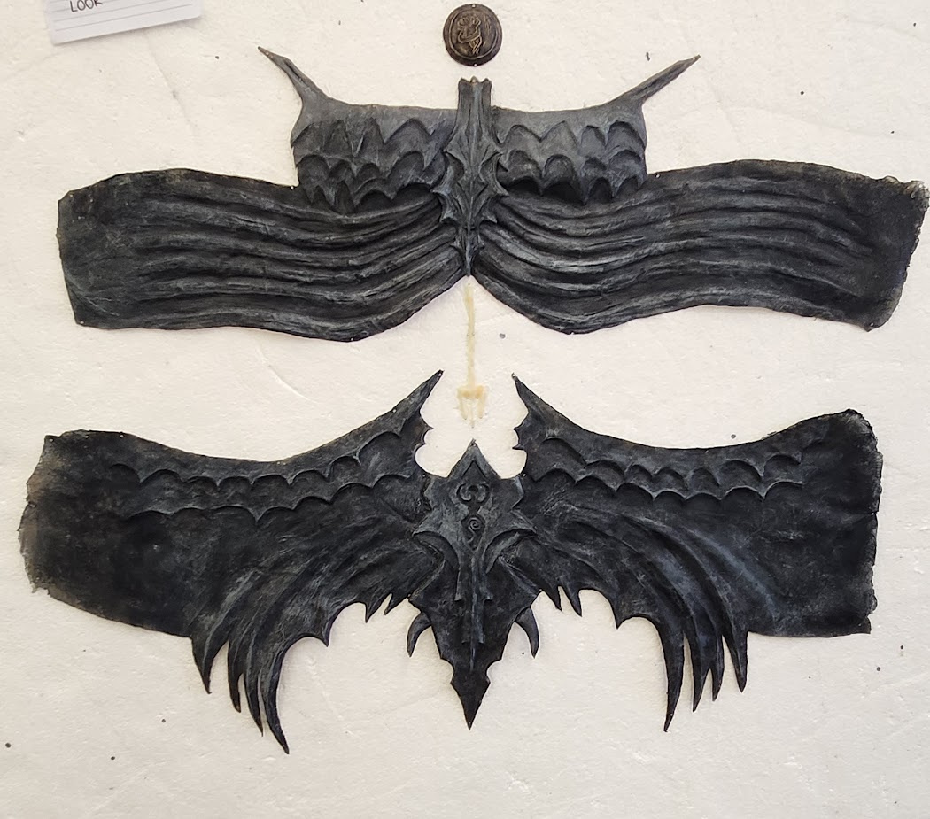 The whole costume prosthetics. Top and bottom parts include 6 separate parts altogether. Above the top part a medallion with a defeated owl is seen and a Poseidon spear scar is between top and bottom parts.