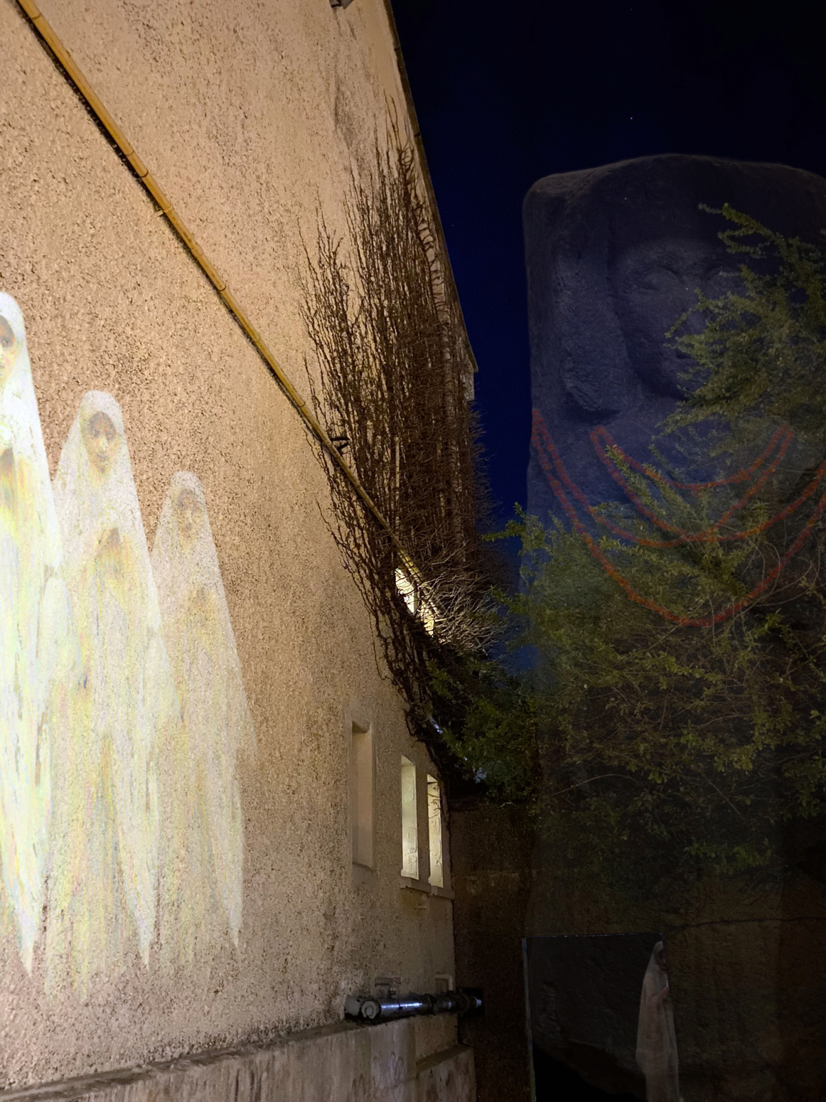 Three Mary's and a "carving of a woman",wearing an amber necklace appearing on the wall of iadt.