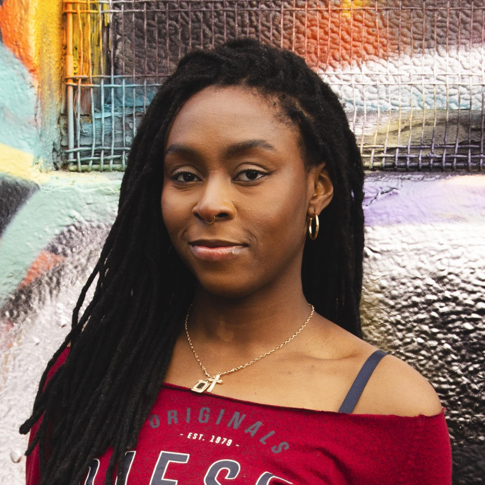 picture of Salem anowe chukwuezi in front of a graffitied wall