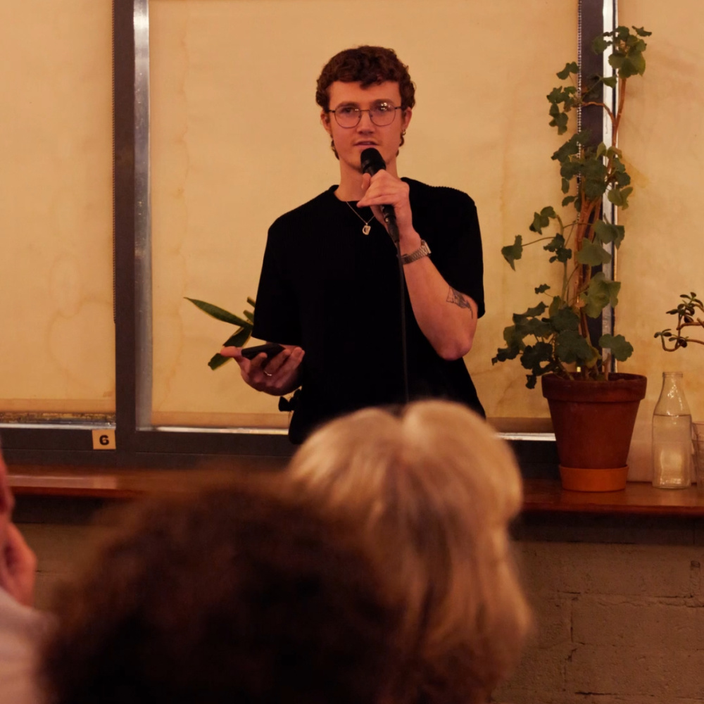 Photo of Darragh speaking at an event in front of a crowd