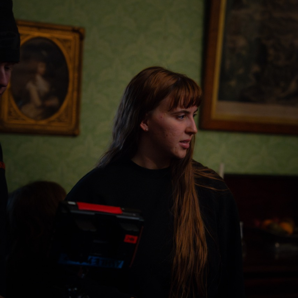 BTS photo of Maria with a camera